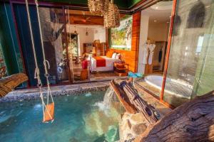 a hotel room with a pool and a bedroom at Villa Lala Boutique Hotel Adults Only in Puerto Vallarta