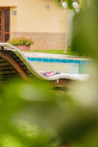 a person laying on a slide next to a swimming pool at Paracuru Kitefriends Lux Pousada in Paracuru