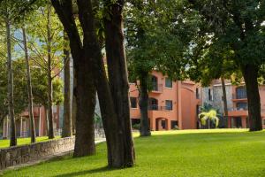 a group of trees in front of a building at Hotel Hacienda Cola del Caballo in Santiago
