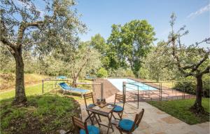 a patio with a table and chairs next to a pool at Casa Le Ginestre in Starda