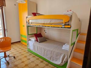 a bedroom with two bunk beds and a desk at Casa vacanze Moretto in Ceglie Messapica