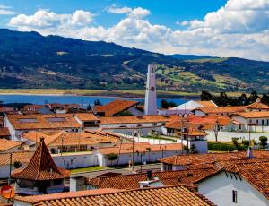 a view of a town with red roofs and a clock tower at Hotel Villa Blanca Guatavita in Guatavita