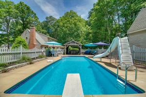 a swimming pool with a slide and a slide slide at Cozy Virginia Vacation Rental with Seasonal Pool! in Nokesville