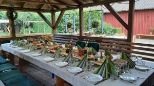 a long table with plates of food on it at "Šventvakarė" in Liaunai