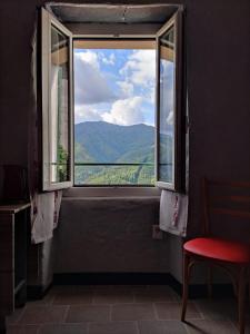 a window with a view of a mountain view at L'Incantesimo in Triora