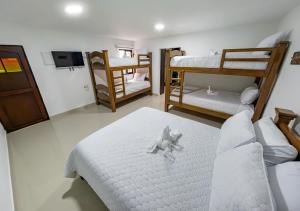 a room with three bunk beds and a tv at Sleep Well in Filandia