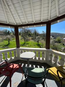 a patio with chairs and a table on a porch at Les 3 Soeurs in Han-sur-Lesse +28 photos