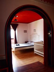 a bedroom with a bed with a red ceiling at Tony's Old Farm in Begunje na Gorenjskem