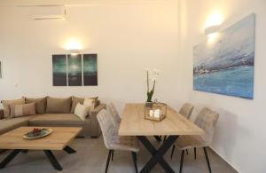 a living room with a table and a couch at Modern Loft Syros in Ano Syros