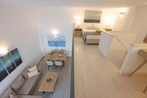 a living room with a couch and a bed at Modern Loft Syros in Ano Syros