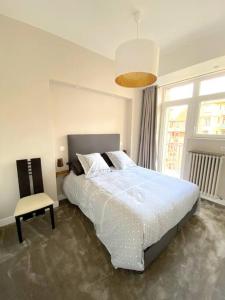 1 dormitorio con 1 cama grande y 1 silla en T3 de 73 m2 , garage , vue montagnes et château, en Annecy