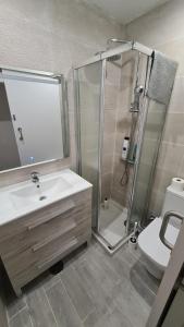 a bathroom with a shower and a sink and a toilet at The Wave Temple in Las Palmas de Gran Canaria