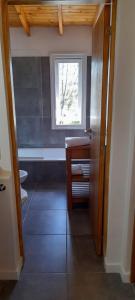 a bathroom with a window and a sink and a toilet at DEPARTAMENTO HOPE 2 in Villa La Angostura