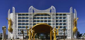 a large white building with gold sculptures in front of it at Azura Deluxe Resort & Spa - Ultra All Inclusive in Avsallar