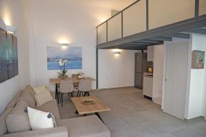 a living room with a couch and a table at Modern Loft Syros in Ano Syros