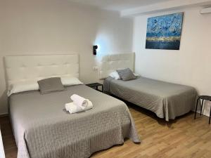 Posteľ alebo postele v izbe v ubytovaní Hostal ARS