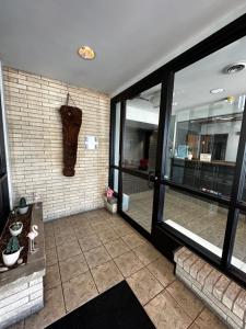 a room with a brick wall and a glass door at Valued Stay Aloha in Madison