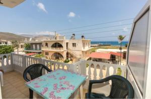 a table and chairs on a balcony with a view at Eleni in Kissamos