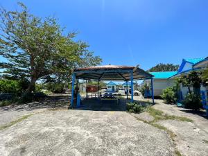 a picnic shelter with a picnic table in a yard at Kenting Dajianshan Cabin in Kenting
