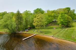 an aerial view of a river with a picnic area at Cozy Carp Lake Cottage with Dock, 4 Kayaks and Fire Pit in Carp Lake