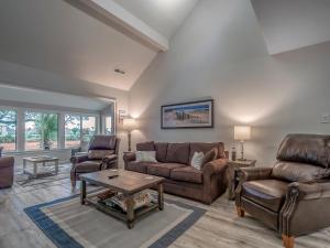 a living room with two couches and a table at 545 Tarpon Pond Cottage in Seabrook Island