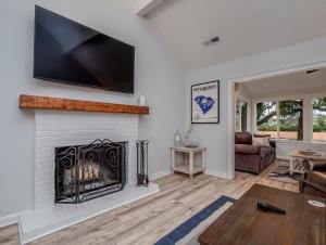 a living room with a fireplace with a flat screen tv at 545 Tarpon Pond Cottage in Seabrook Island