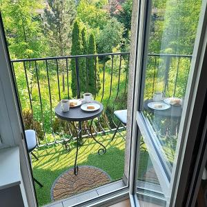 a balcony with a table with two cups of coffee at Apartament Deluxe in Jelenia Góra