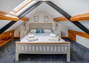 a bedroom with a bed in a attic at Hafod Ganol Farm in Trehafod