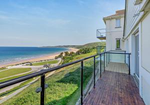 a balcony with a view of the beach at Flat 9 Clifton Court in Croyde