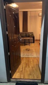 a door leading to a living room with a couch at Tamara`s Apartament in Avlabari in Tbilisi City