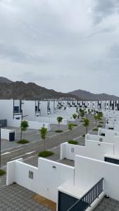 a view of a parking lot with white buildings at Seascape Villa in Fujairah