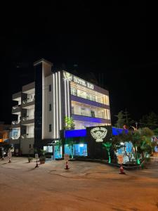 a hotel building with a sign on it at night at Ilio Boutique Hotel in Ksamil