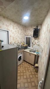 a small kitchen with a sink and a refrigerator at Tamara`s Apartament in Avlabari in Tbilisi City