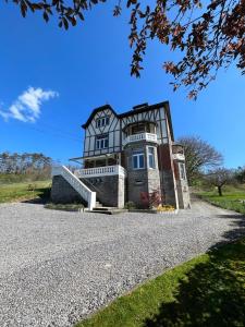 a large house on top of a gravel driveway at Les 3 Soeurs in Han-sur-Lesse