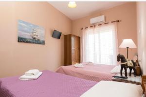 a dog standing on a bed in a room at Eleni in Kissamos