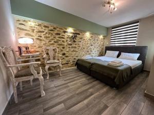 a bedroom with a bed and a table and chairs at Velvethouse in Velventós