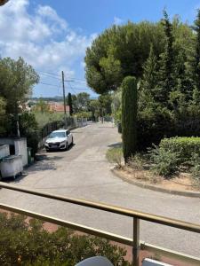 a white car parked on a street with trees at Appartement • Six Fours Les plages in Six-Fours-les-Plages