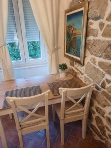 a dining room with a table and two chairs at Old Town Rab Studio apartment in Rab