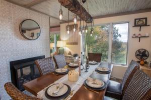 a dining room with a wooden table and chairs at Skyleaf on Sugar in Sugar Mountain