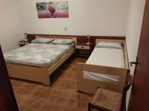 a bedroom with two beds and a painting on the wall at Flavia Flats in Bibione