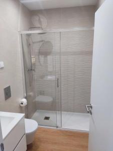 a shower with a glass door in a bathroom at Cabana Sete Ondas in Nazaré +16 photos