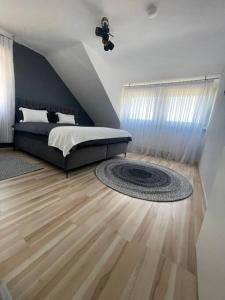una camera con un letto e un tappeto su un pavimento in legno di Ferienwohnung Marie a Rüdesheim am Rhein