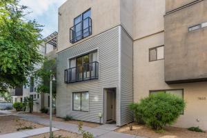 an apartment building with a dog on a balcony at Modern 3 Bed - 3 Bath Townhouse w/ rooftop deck in Phoenix