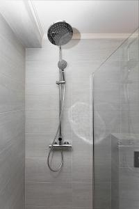 a shower with a shower head in a bathroom at Villa Amari waterfront, step to the sea and berth in Bogišići +120 photos