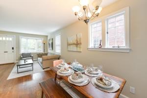 a living room with a table and a dining room at Modern Alexandria Townhome about 2 Mi to Old Town! in Alexandria