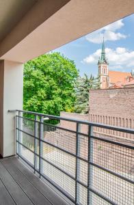 a balcony with a view of a church at Apartament KARMEL in Przemyśl