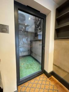 a door with a window in a room with green grass at Duplex Apartment Harbourside city centre in Bristol