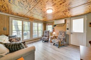 a living room with a couch and two chairs at Waterfront Paradise Lake Cottage with Pvt Dock! in Carp Lake
