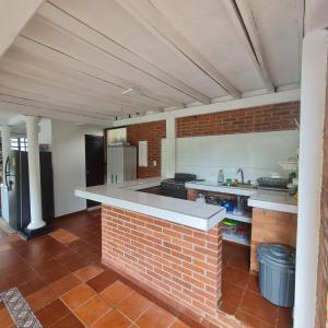 a kitchen with a brick wall and a counter top at MIRADOR VILLA MERCEDES in Melgar