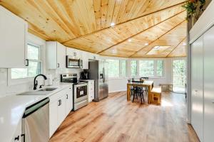 a kitchen with white cabinets and a wooden ceiling at Pocono Pines Penthouse with Private Deck! in Pocono Pines